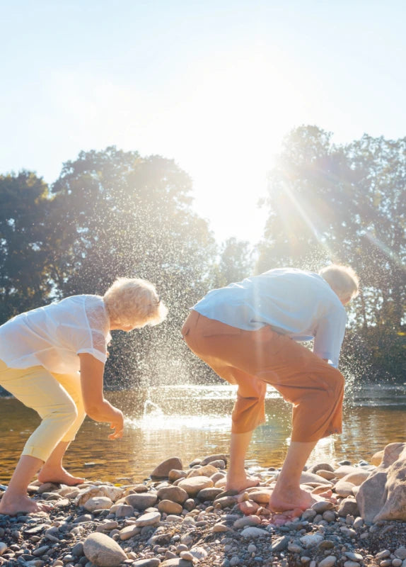 Elderly couple playing in the tidal pools