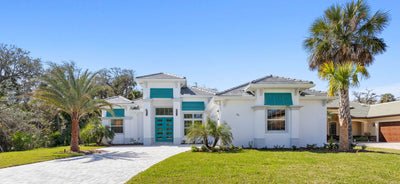 Exterior of white house with blue shutters